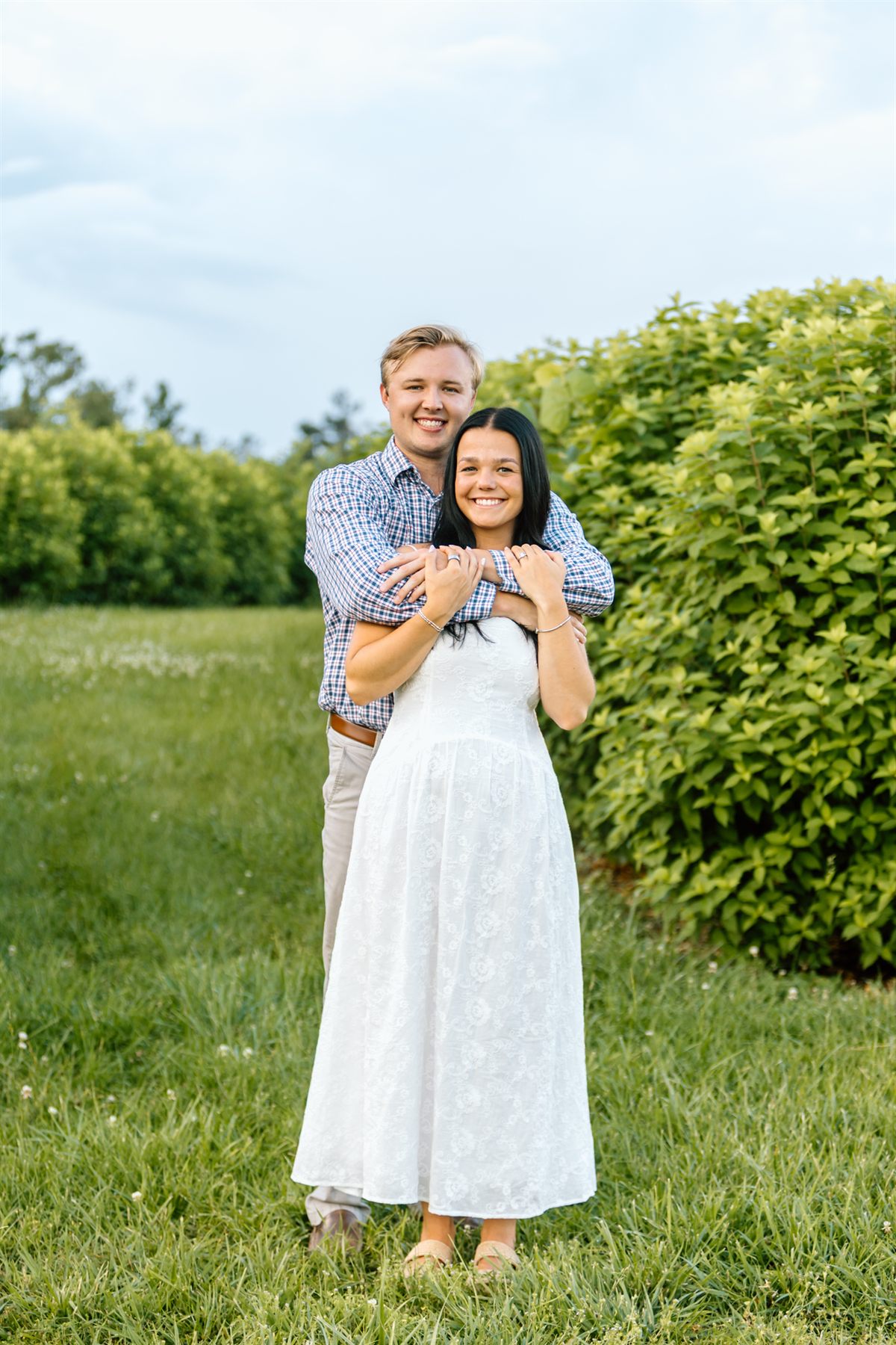 Bailey and Maria standing together in a green garden